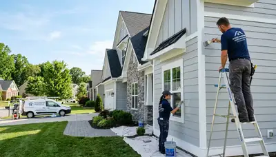 Professional house painters working on exterior home painting in Bloomington, IN